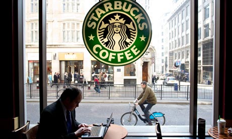 City worker on laptop in Starbucks coffee shop Monument London. Photo:Jeff Gilbert