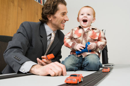 A father and son playing electric shot car